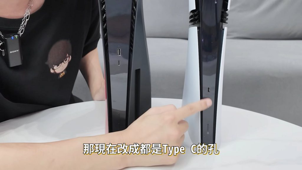 A standard PS5 and a PS5 Pro side by side, a finger pointing at the ports