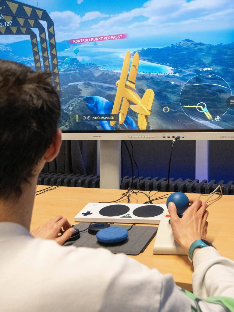 Person using the Xbox Adaptive Controller on a table
