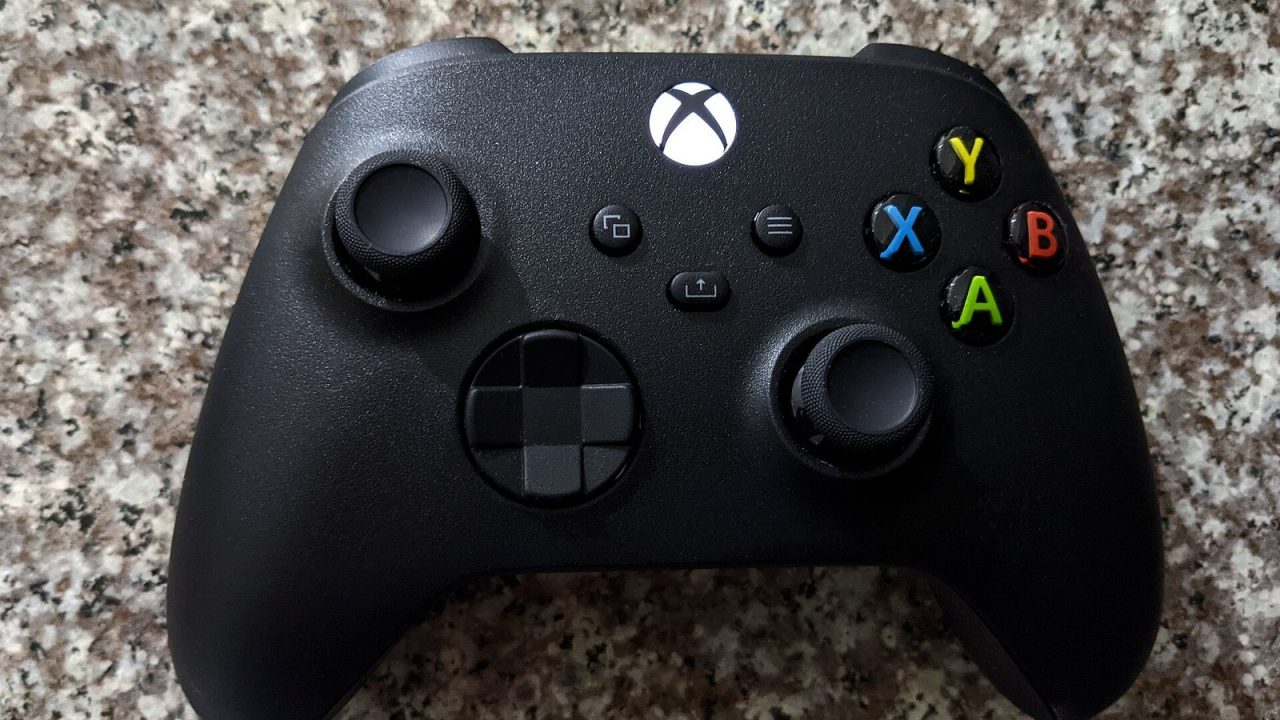 Black Xbox Series wireless controller on a granite surface